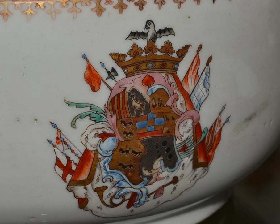 Taza y plato de porcelana con escudo heráldico, arte decorativo.